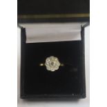 A Gold and Diamond Cluster Ring, Set with a small diamond stone, within eight smaller stones, on