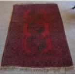 A Turkish Rug, Decorated with three large geometric medallions on a red ground, 150cm x 100cm