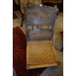 An Indo Portuguese Style Hardwood Chair, Decorated with carved floral roundels above a woven rush