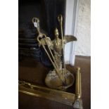 A Gilt Metal Companion Set, Modelled as a bird, having tongs and a poker, 53cm high, also with a