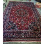 A Large Persian Carpet, Decorated with multiple floral medallions and motifs on a red ground,