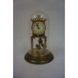 A German Brass Anniversary Clock, 20th century, with initial B to dial, 23cm high, beneath a glass