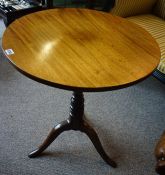 A George III Mahogany Tea Table, Having a circular snap action top, raised on a turned column and
