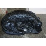 A Large Black Painted Companion Figure of a Spaniel Dog, stamped H.G.C, 45cm wide