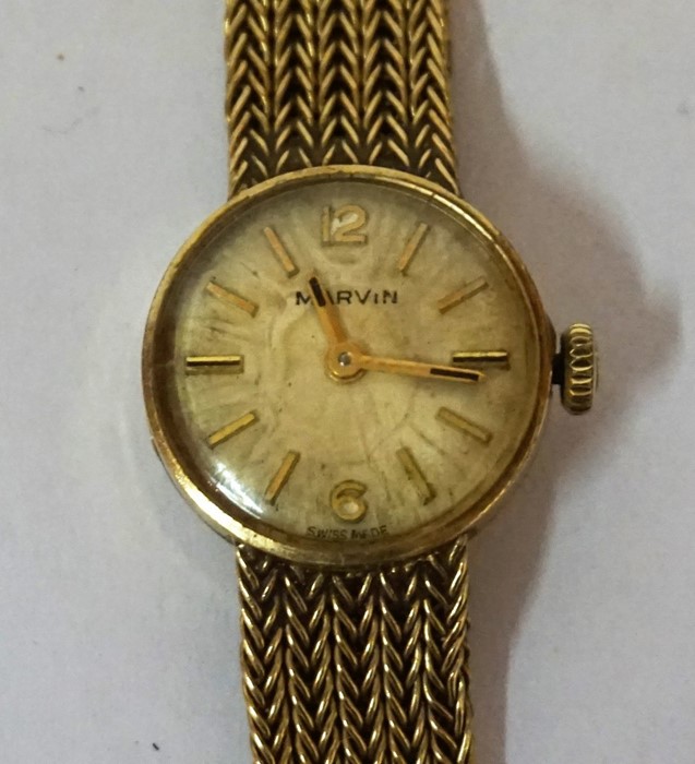 A 9ct Gold Ladies Swiss Made Wristwatch by Marvin, With baton numerals to the dial, on a gold mesh