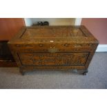 A Chinese Style Carved Camphorwood Blanket Chest, Decorated with carved panels of figures, lock