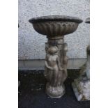 A Painted Bronze Coloured Stone Bird Bath, Modelled as classical females holding aloft the top,