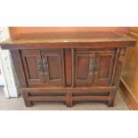 A Chinese Style Hardwood Cupboard, Having two pairs of two doors enclosing a shelved interior,