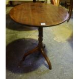 A George III Mahogany Tea Table, Having a circular snap action top, raised on a turned column and