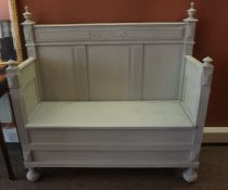 A French Painted Oak Hall Settle, Having a hinged seat, 135cm high, 135cm wide, 50cm deep