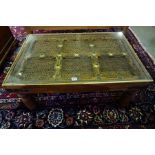 An Indonesian Hardwood Coffee Table, Having a paste shutter interior, 37cm high, 90cm wide