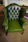 A Chesterfield Green Leather Wing Armchair by Thomas Lloyd, 114cm high