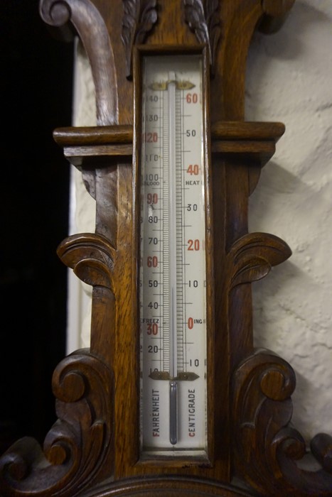 An Edwardian Carved Oak Wheel Barometer, Having a thermometer gauge above enamel dial, 88cm high - Image 3 of 3