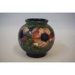 A Moorcroft Oviform Vase, Tube lined with flowers on a green and blue ground, 14cm highCondition
