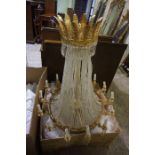 A Regency Style Crystal Chandelier, Of large form, The top having gilded leaf decoration, Draped