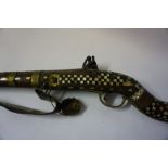 An Indian Flintlock Gun, circa early 19th century, Having a metal ramrod, The walnut stock and