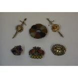 Six Assorted Scottish Brooches, To include a silver Iona style brooch, a silver brooch, and a pebble