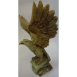 An Oriental Carved Soapstone Model of an Eagle, 20th century, Standing on a rock, 31cm high