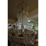 A Continental Crystal Chandelier, Of large form, Having brass and gilded mounts, candle sconces to