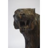 A Carved Wood Figure of a Tiger, Raised on a carved base, 32cm high