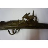 An Eastern Flintlock Long Gun, circa 19th century, Having ramrod, walnut butt and stock, white metal