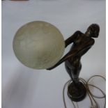 Art Deco Style Table Lamp, Modelled as a reclining nude female holding the glass light shade, fitted