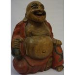An Oriental Carved and Painted Wood Figure of a Laughing Buddha, Drinking from a bottle, 42cm high