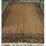 A Pakistani Bokhara Carpet, Decorated with multiple rows of geometric motifs on a red ground,