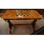 A Victorian Walnut and Mahogany Games table, Having an inlaid draughts surface to the top, above