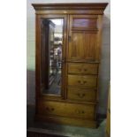 A Late Victorian Walnut Wardrobe, Having a cuboard door above three small drawers, flanked by a