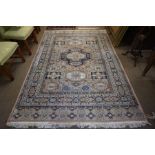 A Persian Rug, Decorated with allover geometric medallions and motifs, on a pink and cream ground,
