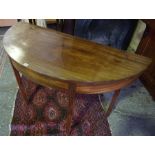 A Mahogany Demi Lune Table, Raised on reeded tapered legs, 72cm high, 126cm wide, 55cm deep