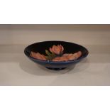 A Moorcroft Tube Lined Bowl, Decorated with a panel of pink flowers, on a blue ground, signed to