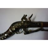 An Indian Flintlock Gun, Signed Wilson 1801, Having a metal ramrod, walnut butt and stock, the