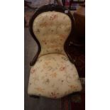 A Victorian Mahogany Ladies Parlour Chair, Upholstered in later fabric, having a serpentine shaped