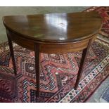 A Mahogany Demi Lune Tea Table, Having a fold over top, raised on tapered legs, 73cm high, 92cm