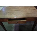 A Victorian Pine Farmhouse Table, Having a single drawer and drop end, 76cm high, 107cm wide, 94cm