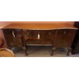 A Chippendale Style Mahogany Serpentine Sideboard, circa 19th century, Having a large drawer above a