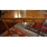 A William IV Mahogany Writing Table, circa 1830, Having two small drawers, raised on turned legs,