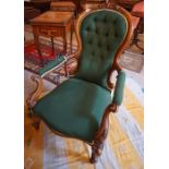 A Victorian Walnut Parlour Armchair, Upholstered in later green button back fabric, raised on scroll