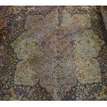 A Large Persian Design Machine Woven Carpet, Decorated with floral panels on a blue ground, cut to