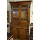 A Victorian Plum Pudding Mahogany Bookcase on Secretaire Base, Having two glazed doors, enclosing