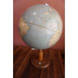 A Revolving World Globe, Raised on a walnut style stand, inset with compass, approximately 62cm