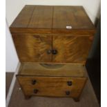 A Georgian Mahogany Washstand, Having a pull out top, enclosing a fitted interior, above two doors