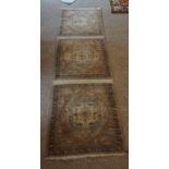 An Old Konya Rug, Decorated with three geometric medallions, on a beige ground, 202cm x 60cm