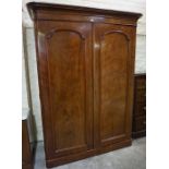 A Victorian Mahogany Wardrobe, Having two doors enclosing hanging space to the left and fitted