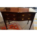 A Georgian Style Serpentine Chest of Drawers, 20th century, Having four small drawers with brass