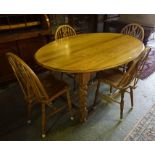 An Ercol Dining Table with Four Windsor Style Chairs, The D end table is raised on barley twist