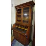 A William IV Mahogany Bookcase on a Cylinder Bureau Base, Having two doors, enclosing a shelved