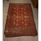 An Antique Turkoman Rug, Decorated with five rows of two geometric medallions, on a red ground,